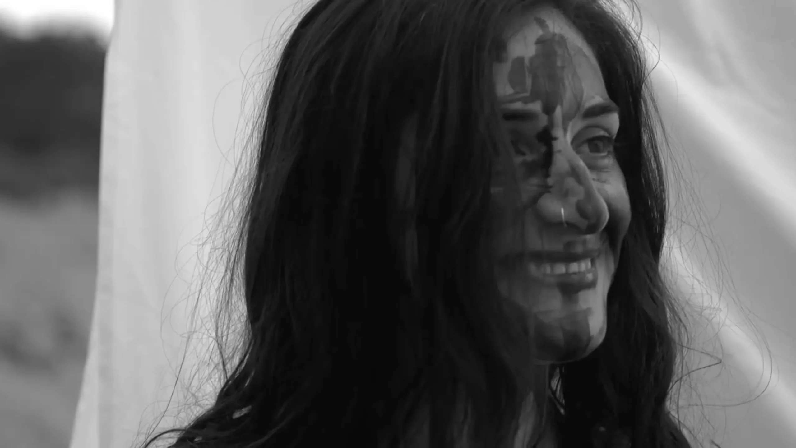Eva Moro with paint on her face and hair over her eyes — Lost